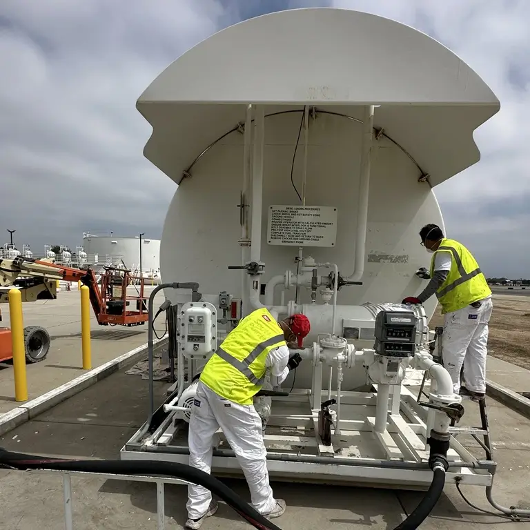 Commercial surface preparation for tank refinishing including hand and power tool cleaning and solvent wash.