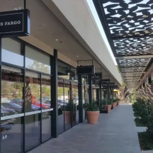 Commercial tenant improvement painting and walkway pressure washing completed at a retail shopping strip.