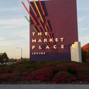 Commercial property maintenance painting including professional exterior repaint completed on The Market Place entry sign.